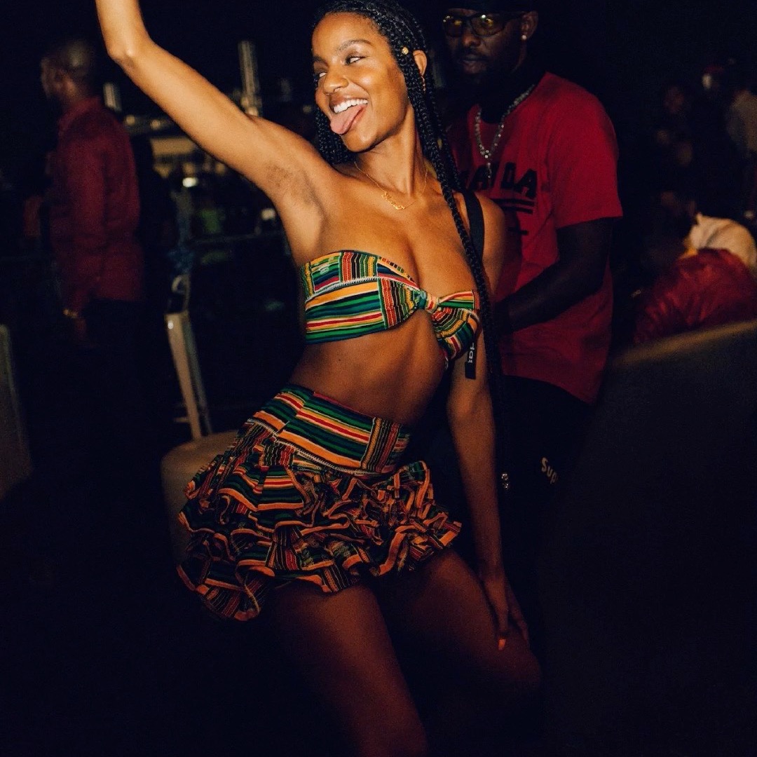 Guest in colorful festival outfit dancing at night